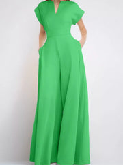 Neon green wide-leg romper with pockets and notched neckline.