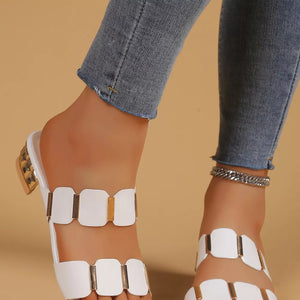White block heel sandals with gold accent straps and a textured heel.