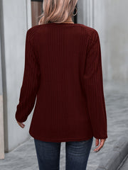 Burgundy ribbed knit raglan sweater with button trim detail.