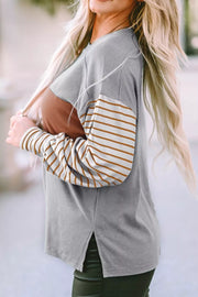 Maternity shirt with bishop sleeves, crew neck, and colorblock design in gray and mustard stripes.