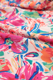 Floral blouse with flutter sleeves and tie-neck detail in a vibrant floral print.