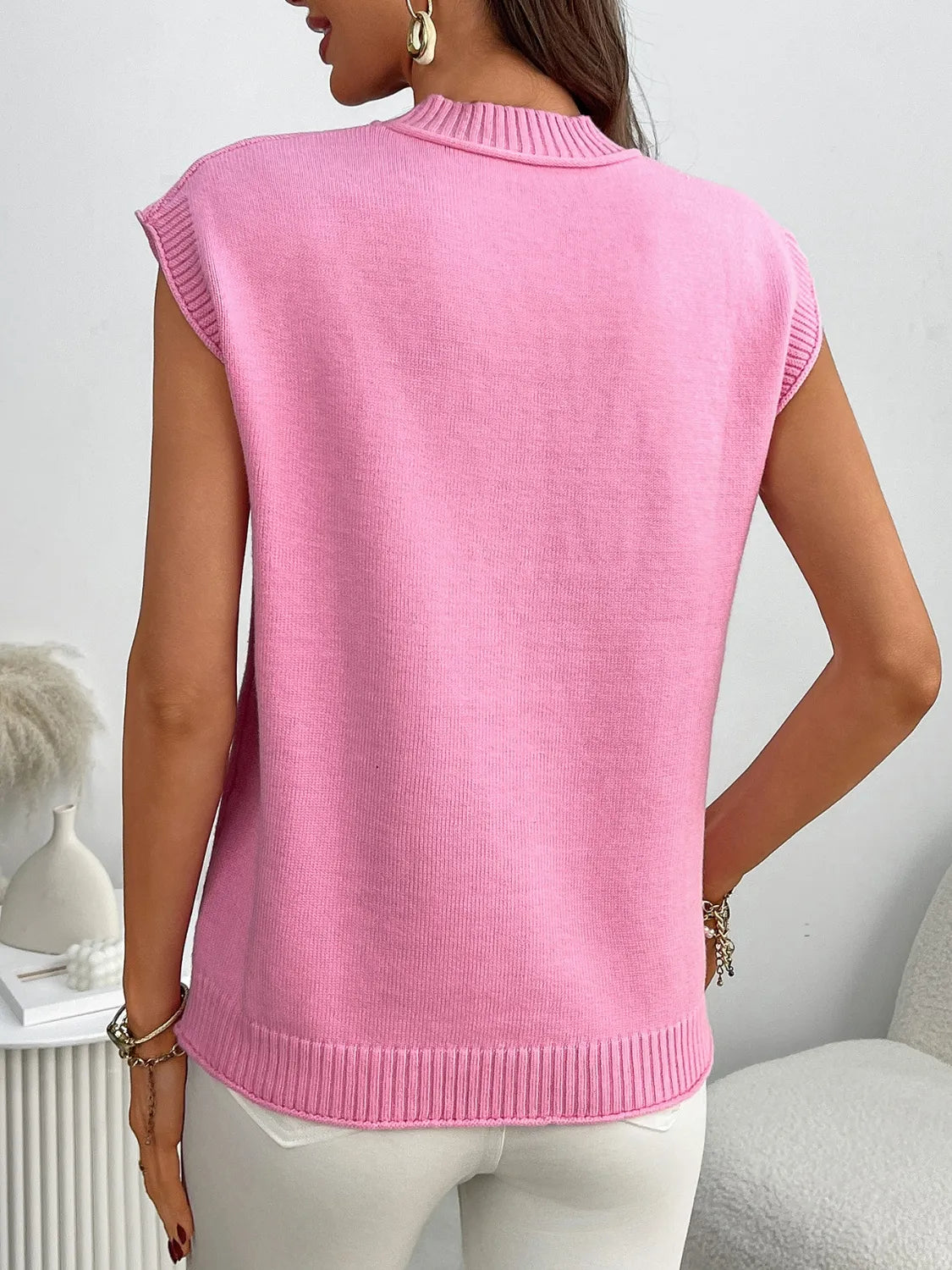 Pink ribbed knit sleeveless mock neck top with a relaxed fit.