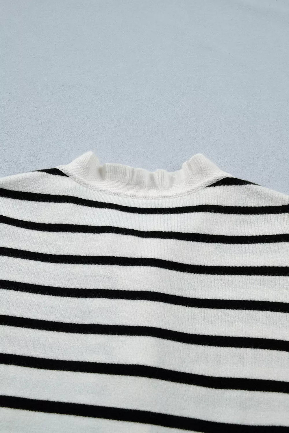 Chic striped maternity cardigan with ruffle-trim neckline.