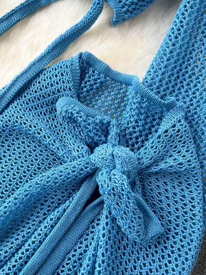 Blue knit tied crop top with open weave detail and tie closure.