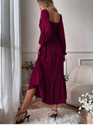 Burgundy midi dress with smocked bodice, puff sleeves, and ruffled hem.