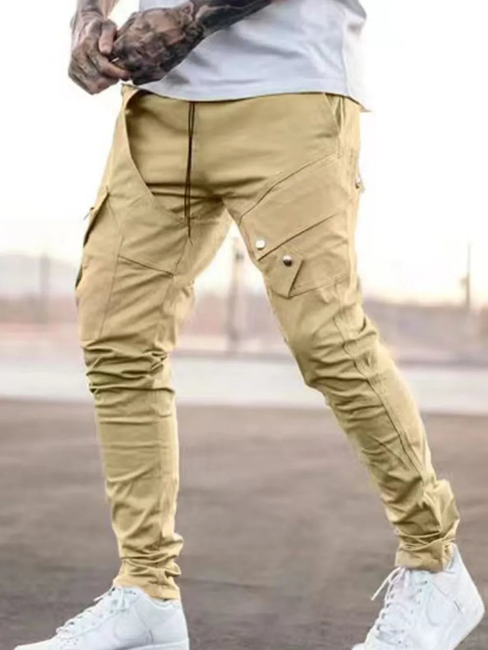 Tan zip pocket slim cargo trousers with multiple pockets and a drawstring waist.