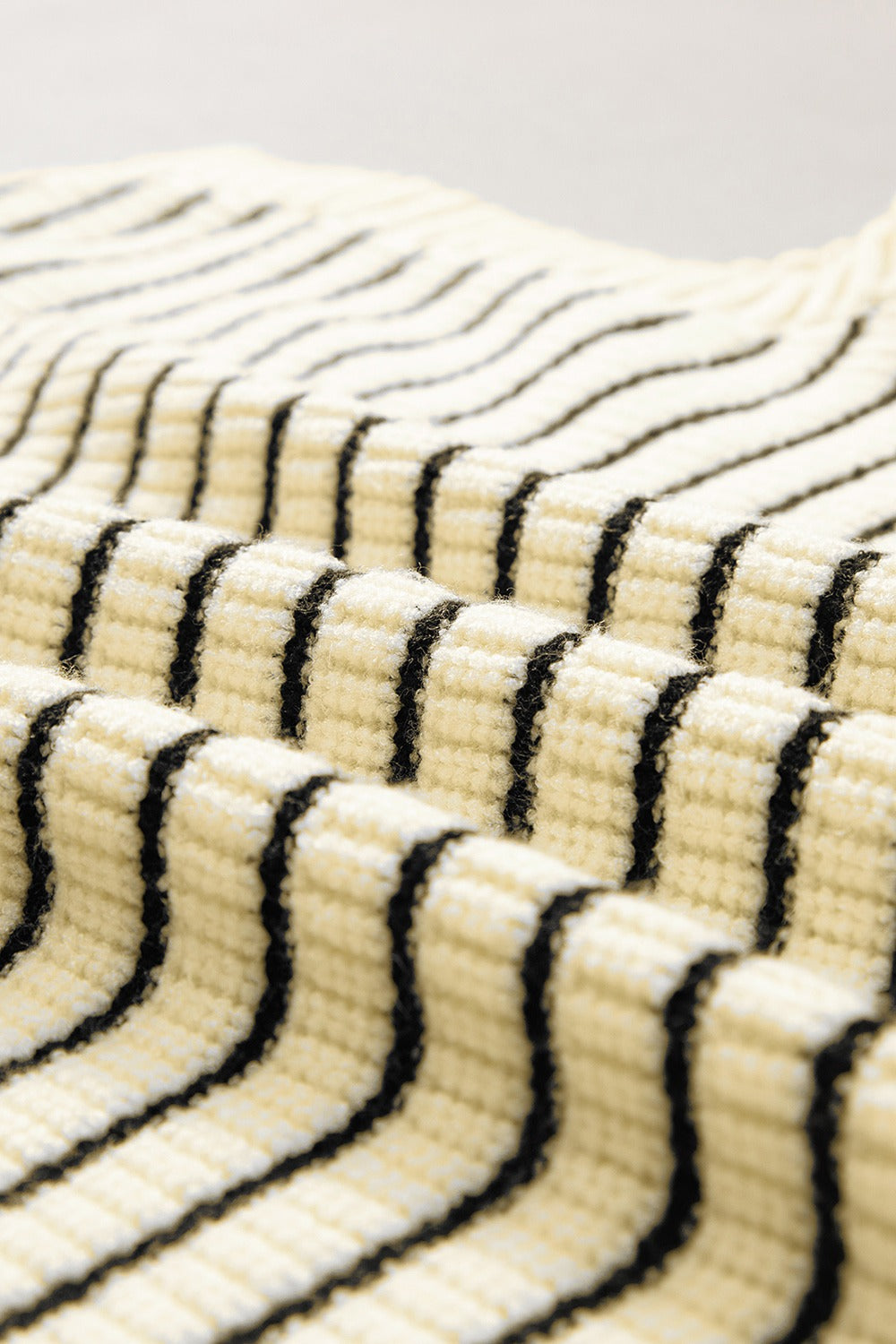 Ivory knit polo vest with black stripes, textured ribbed fabric detail