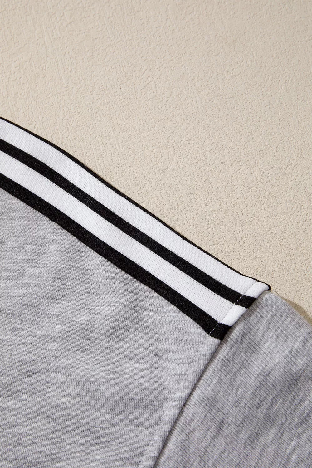 Grey relaxed t-shirt with black and white shoulder stripes