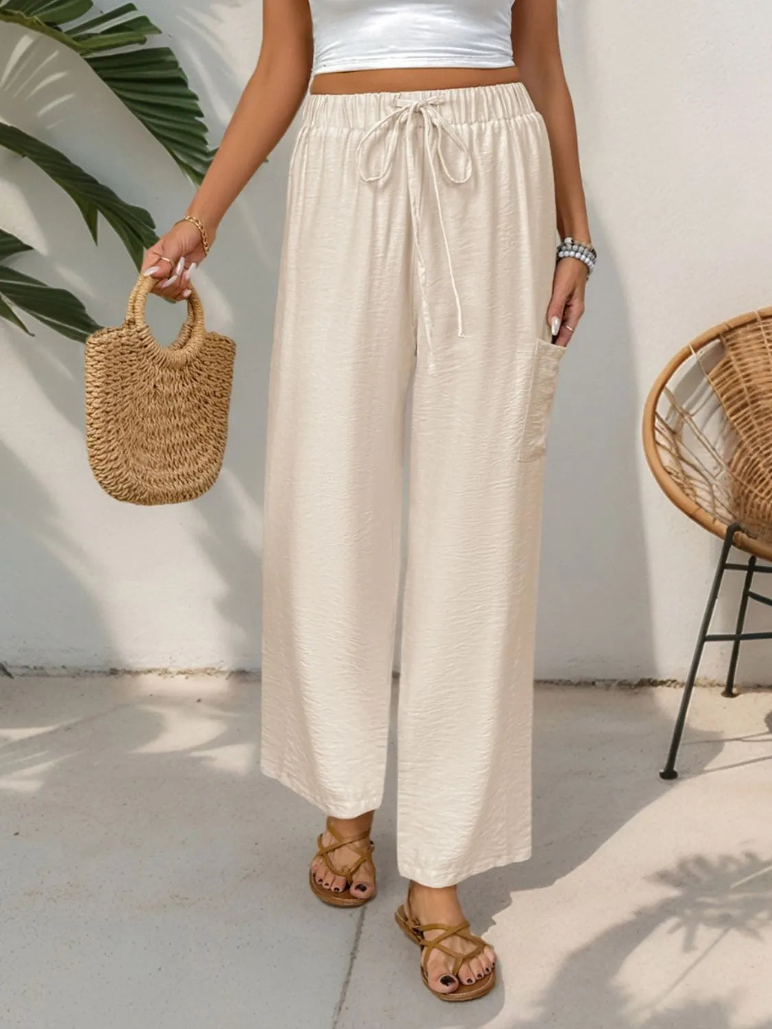 Chic waist-tie flare trousers in tan with a drawstring and side pocket.