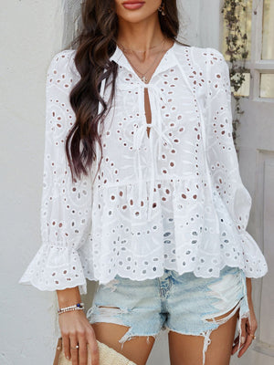 White eyelet embroidered peplum blouse with tie neck and ruffled bell sleeves