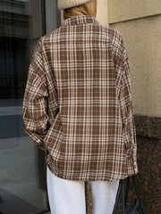 Brown plaid shacket with button-up front and pockets, styled casually.