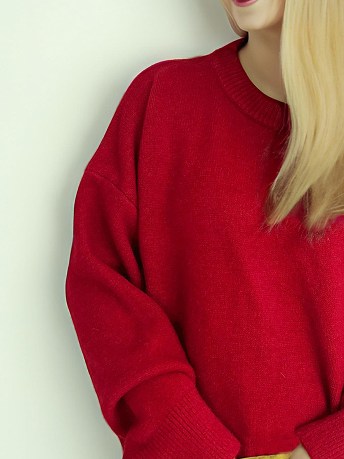 Oversized crewneck knit pullover in red acrylic with ribbed cuffs and neckline.