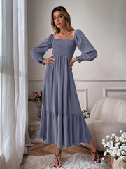 Smocked midi dress in dusty blue with square neckline, puff sleeves, and tiered ruffle hem.