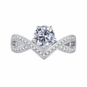 Sterling silver crossover ring with moissanite stones and a central round-cut diamond.