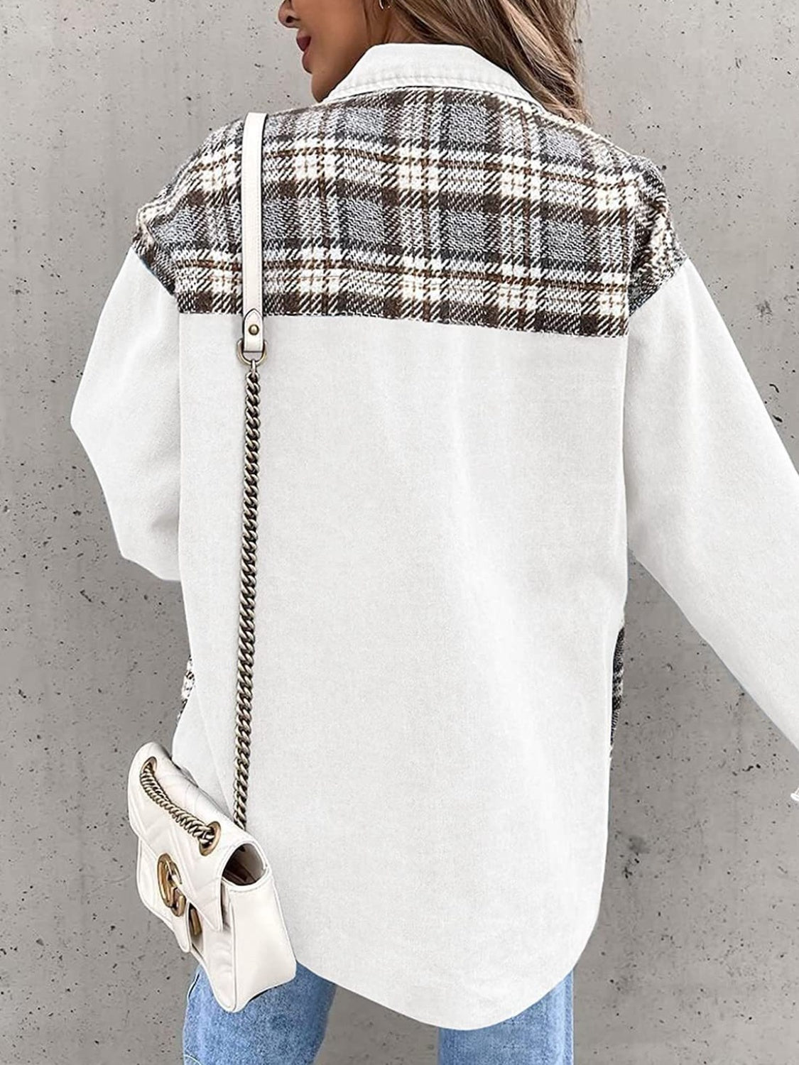 White denim jacket with brown plaid paneling on the upper back and sleeves.