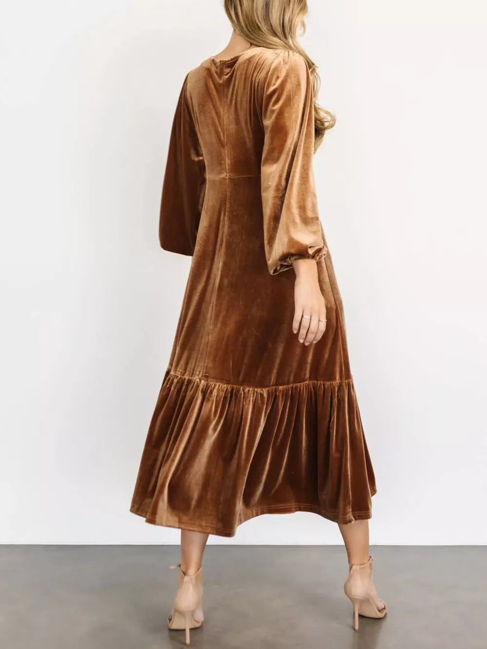 Gold velvet midi dress with tiered skirt and balloon sleeves.