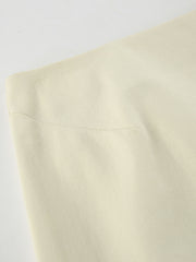 Chic cotton midi skirt in beige, featuring a subtle ribbed texture and a side slit detail.