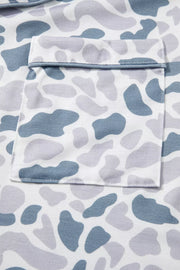 Blue camouflage print pajama set with button-down top and chest pocket detail.