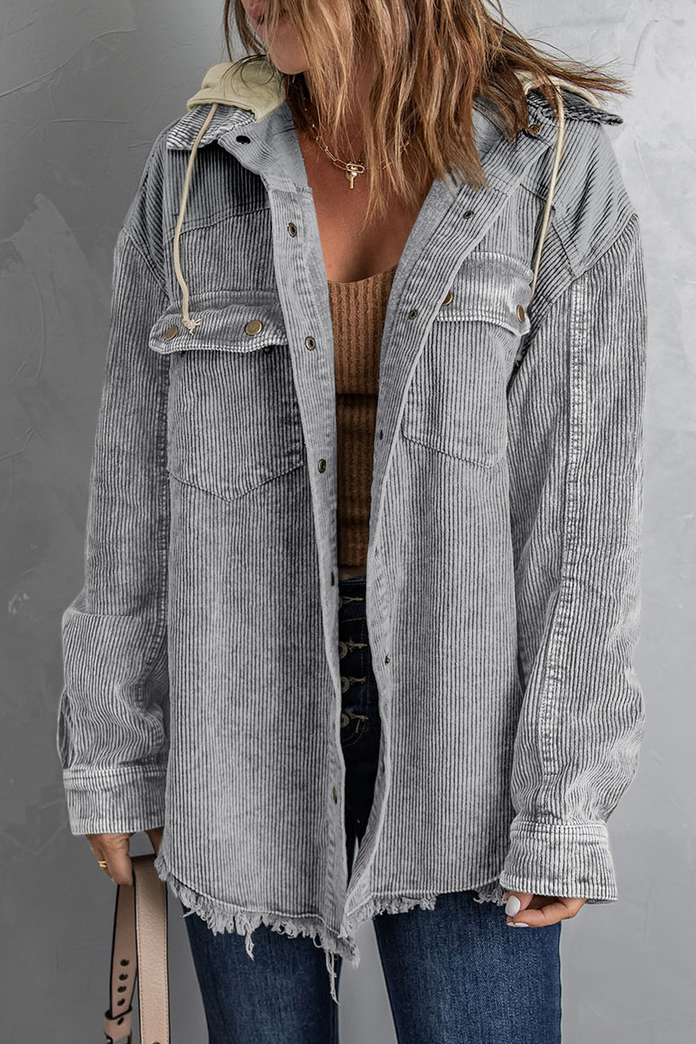 Gray corduroy hooded utility jacket with frayed hem and drawstring hood.