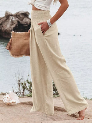 Tan smocked wide-leg maternity pants with pockets, styled casually.