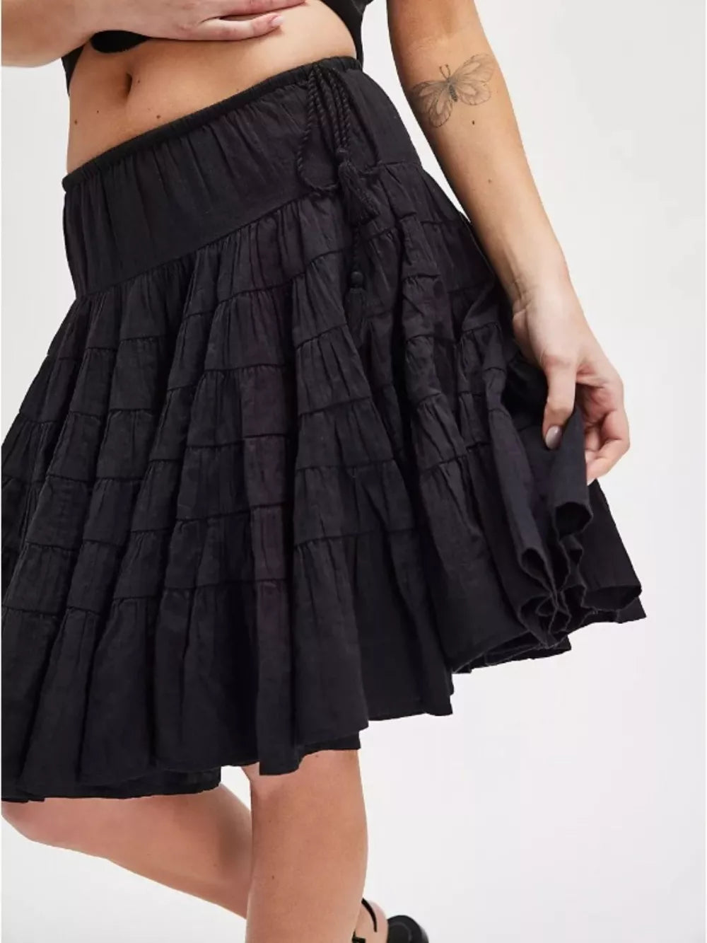 Black tiered drawstring mini skirt with ruffled hem detail