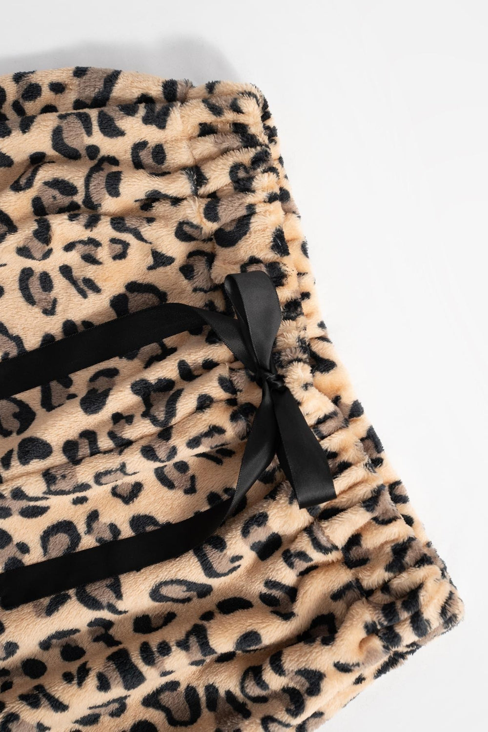 Leopard plush palazzo lounge pants with black ribbon tie detail.