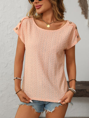 Peach eyelet knit tee with button shoulder detail and short sleeves.
