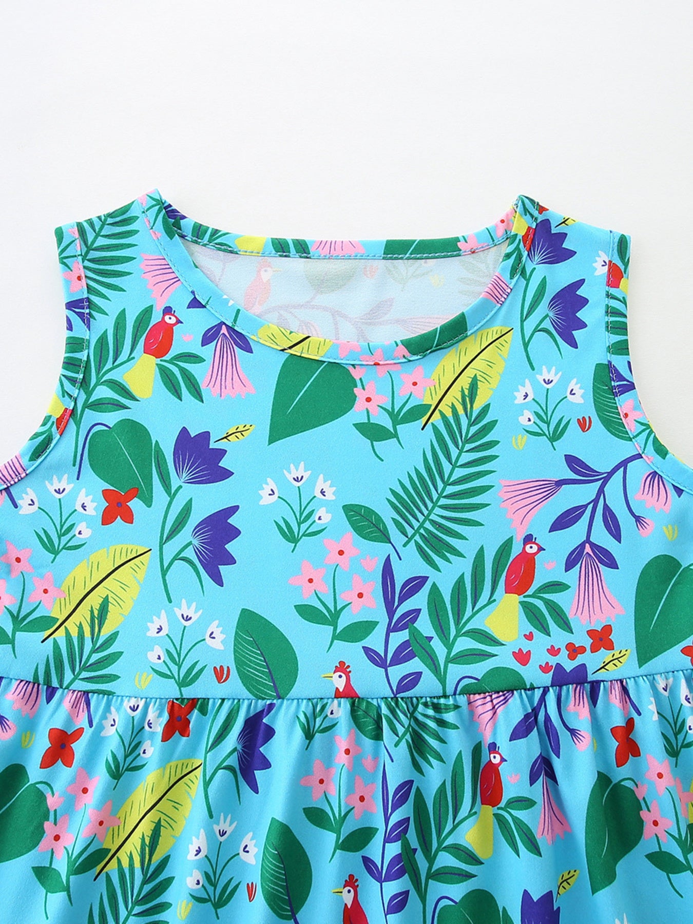 Toddler sleeveless dress with tropical floral and bird print, round neck, peplum hem.