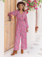 Paisley ruffle front wide leg jumpsuit in hot pink with long sleeves and a v-neck.