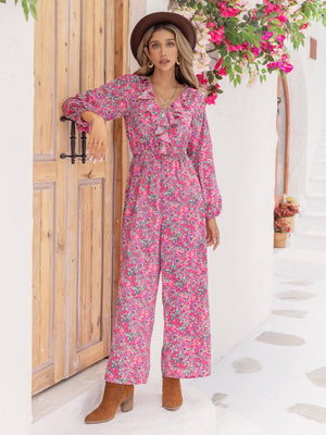 Paisley ruffle front wide leg jumpsuit in hot pink with long sleeves and a v-neck.