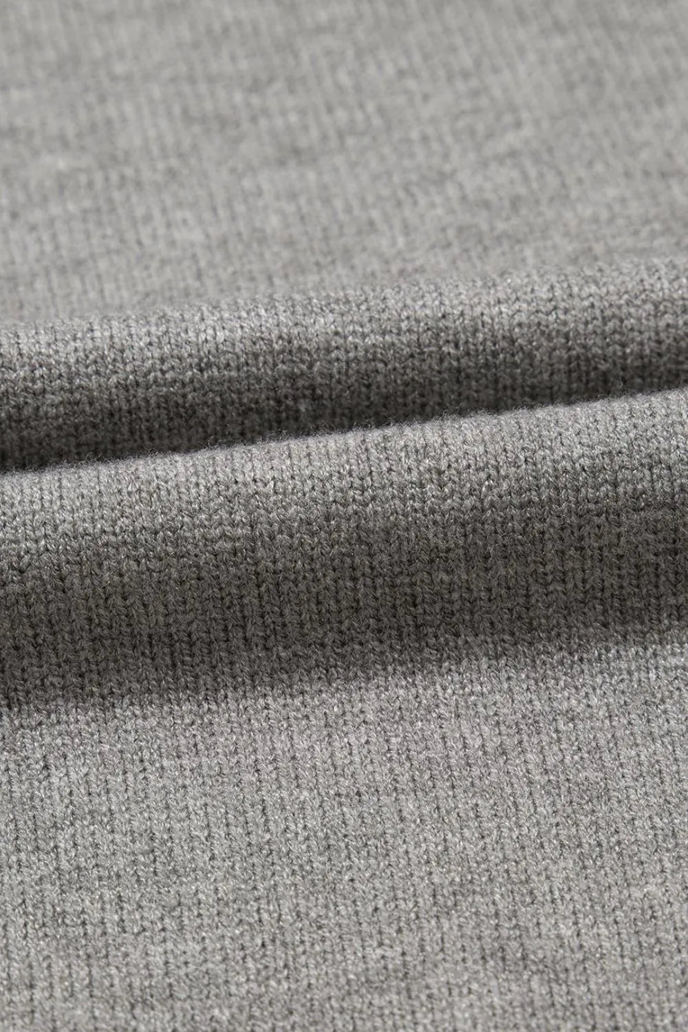 Gray knit top with a subtle ribbed texture, close-up detail.