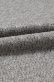 Gray knit top with a subtle ribbed texture, close-up detail.