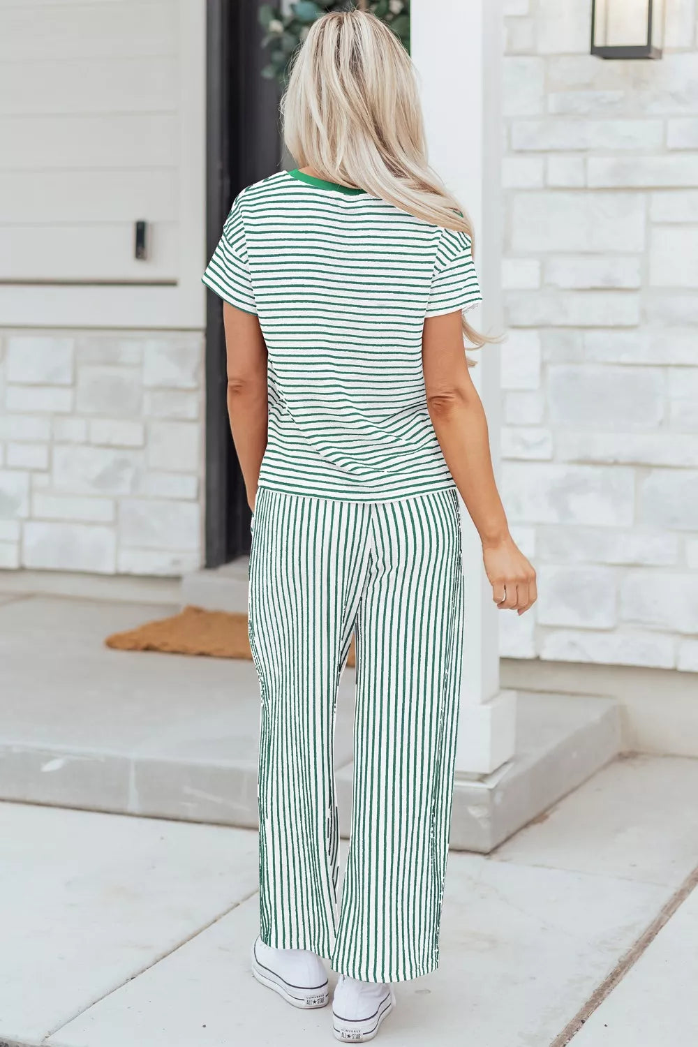 Green and white striped pajama set with crew neck top and drawstring pants.