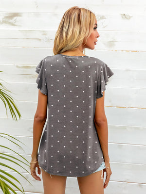 Gray Dawn polka dot tee with ruffled sleeves and a curved hem.