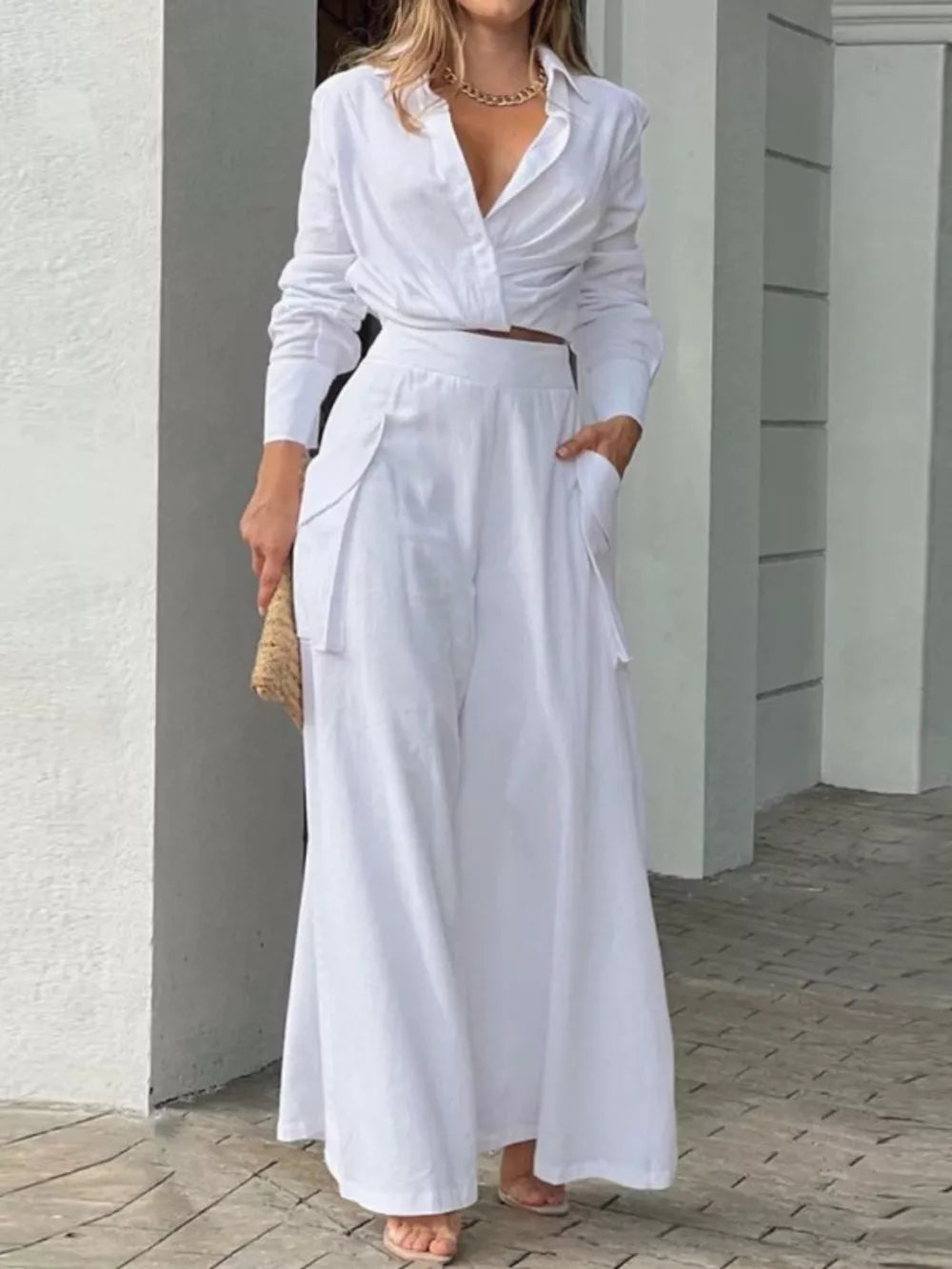 White polyester two-piece set with pocketed wide-leg pants and a cropped collared shirt.