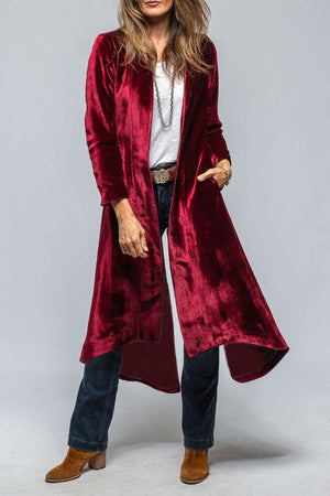 Burgundy velvet duster coat with dramatic split back, open front, long sleeves, and pockets.