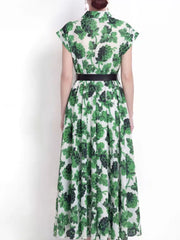 Green botanical print collared midi dress with a black belt.