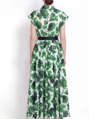 Green botanical print collared midi dress with a black belt.