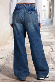 Medium wash denim palazzo jeans with elastic waist and patch pockets.