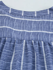 Dusty blue striped V-neck blouse with a buttoned front and gathered waist detail.