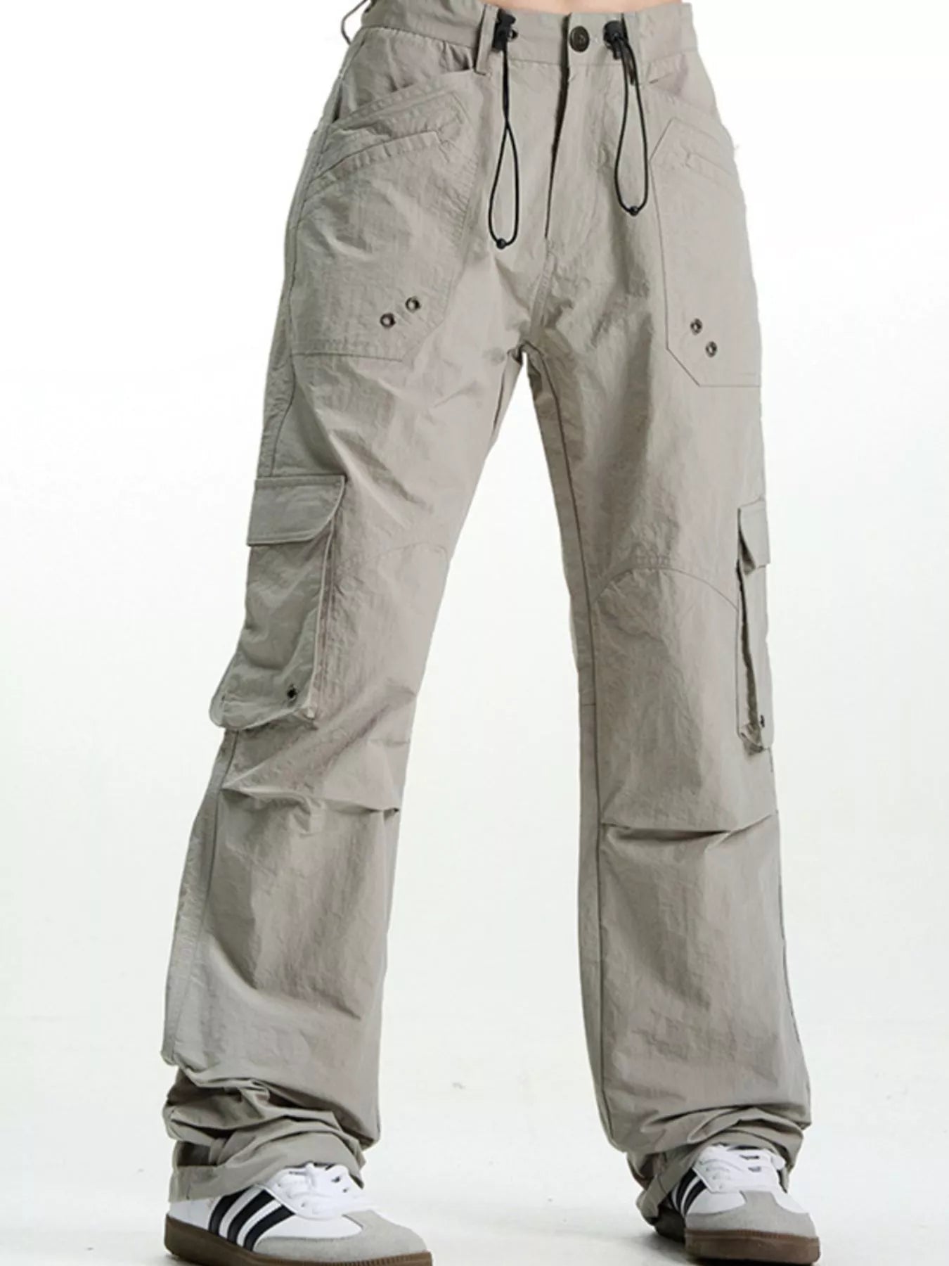 Grey relaxed fit cargo pants with multiple pockets and drawstring waist.