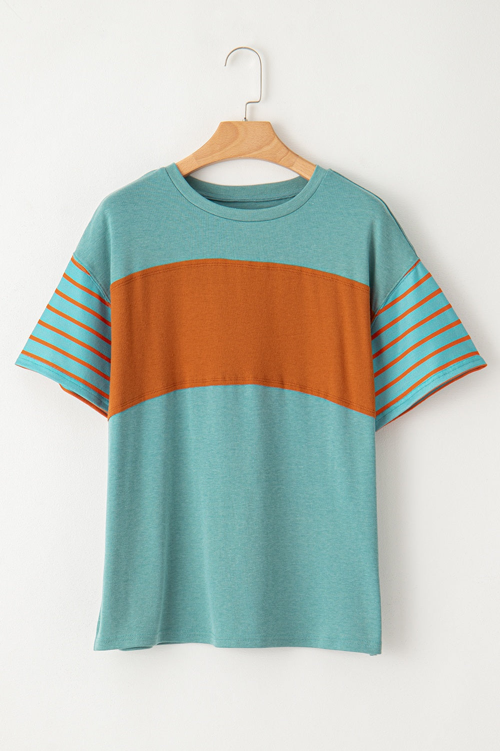 Colorblock raglan tee in turquoise with orange stripe sleeves and chest band.