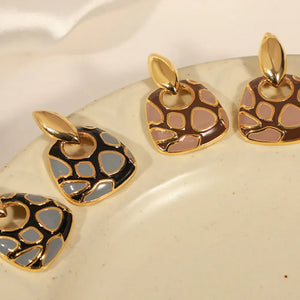 Geometric enamel drop earrings in black and brown with gold accents.