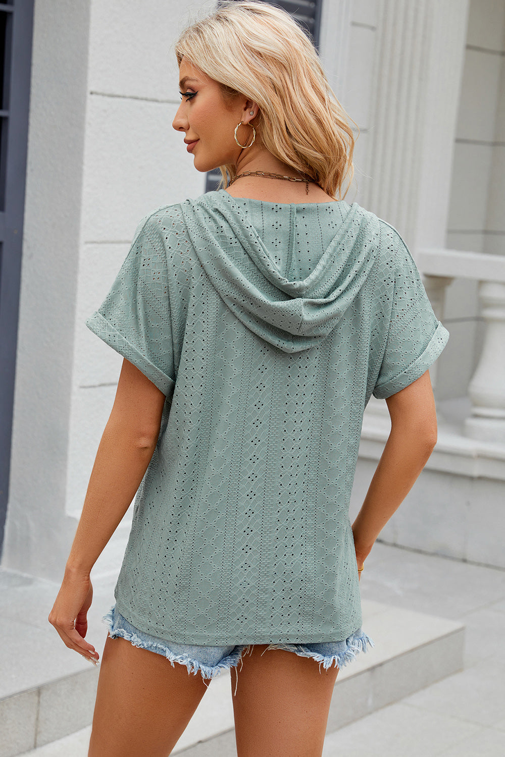 Light Green perforated henley hooded tee with short sleeves and a relaxed fit.