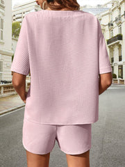 Pink waffle knit drawstring co-ord set with short sleeves and shorts.