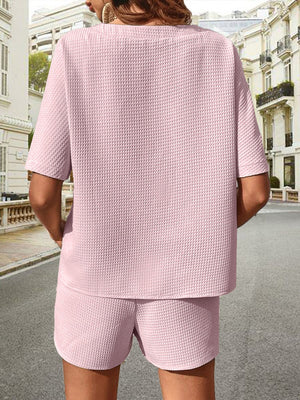 Pink waffle knit drawstring co-ord set with short sleeves and shorts.