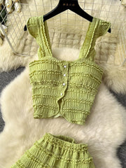 Light green textured ruffled two-piece set with buttoned crop top and ruffled skirt.