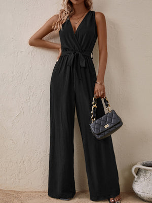 Black textured wrap-front wide-leg jumpsuit with tie waist and V-neck.
