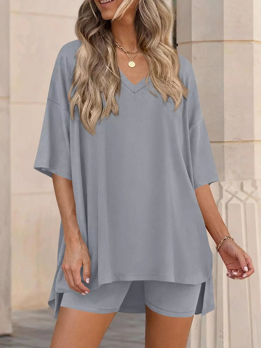 Gray V-neck two-piece set with oversized short-sleeve top and shorts.