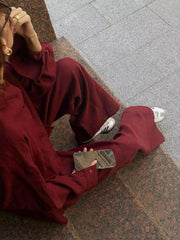 Burgundy relaxed fit two-piece set with button-up shirt and wide-leg pants.